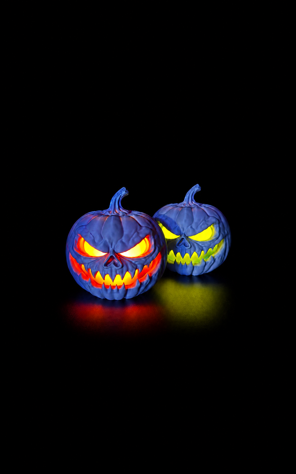 Two glowing jack-o'-lantern decorations fully visible against a black background