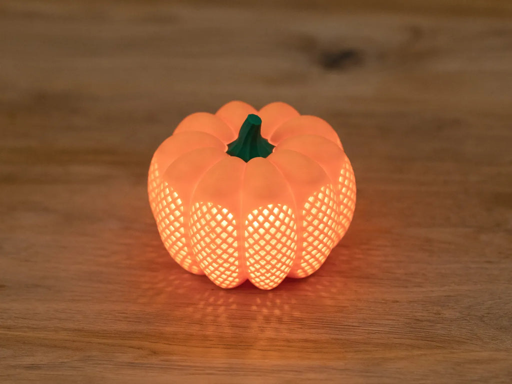 Orange Modern Pumpkin Tea Light with a green stem and illuminated lattice pattern, 10 cm diameter
